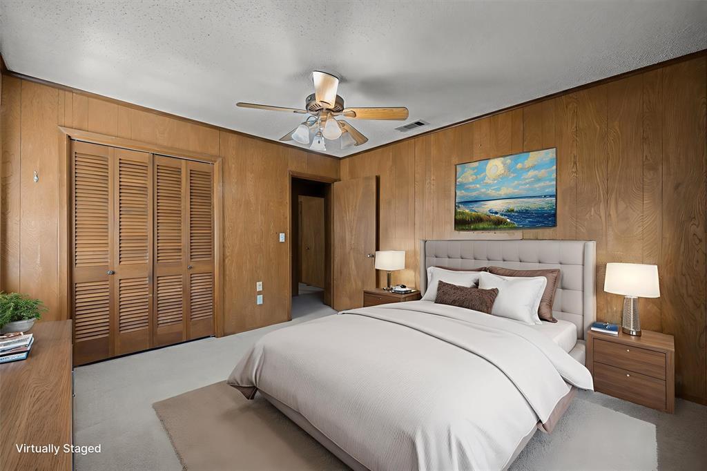 3121 County Road 1215 Canton, TX 75103 - Photo 26 of 40 a bedroom with a large bed and a chandelier