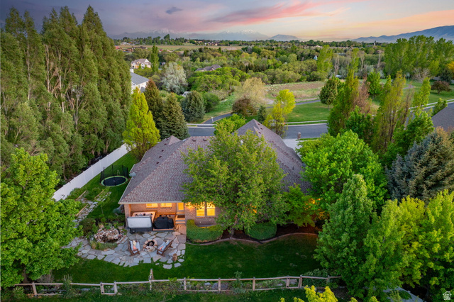 6208 West Bull River Road Highland, UT 84003 - Photo 66 of 90 Aerial view showcasing the property's expansive green lawn, mature trees, and mountainous backdrop