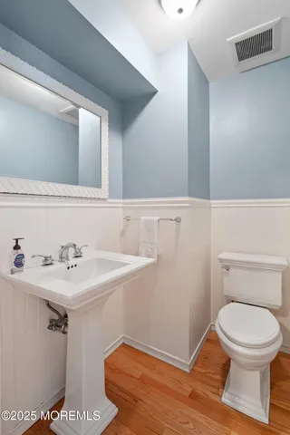 a bathroom with a sink a toilet and a mirror