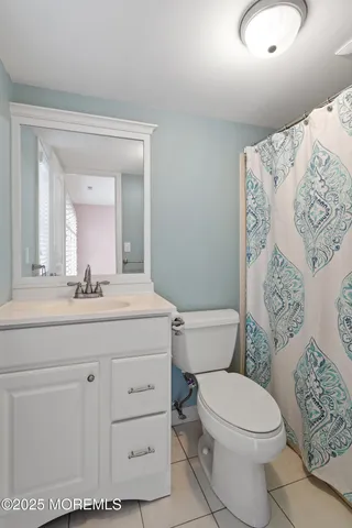 a bathroom with a toilet a sink and a mirror