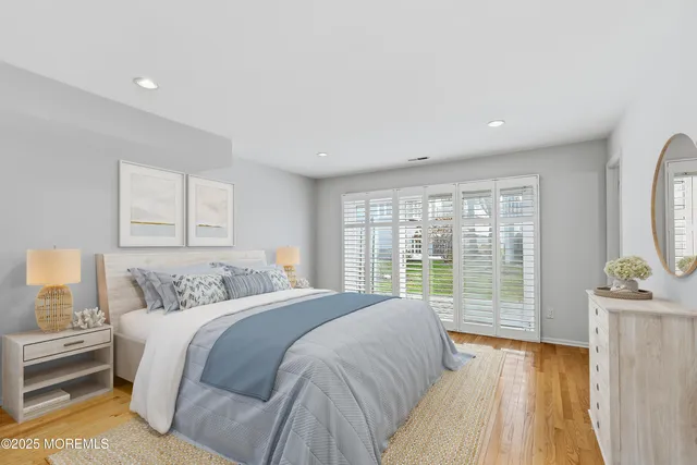 a bedroom with a large bed and a large window
