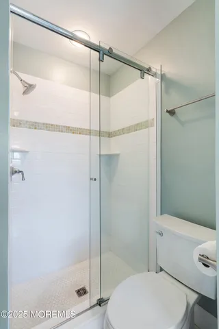 a bathroom with a shower and a toilet