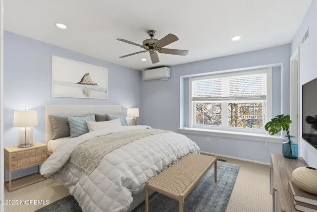 a spacious bedroom with a large bed and a chandelier