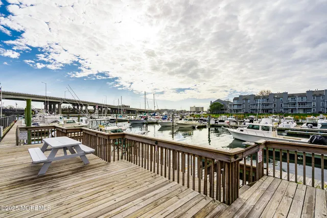 a balcony with wooden floor and city view