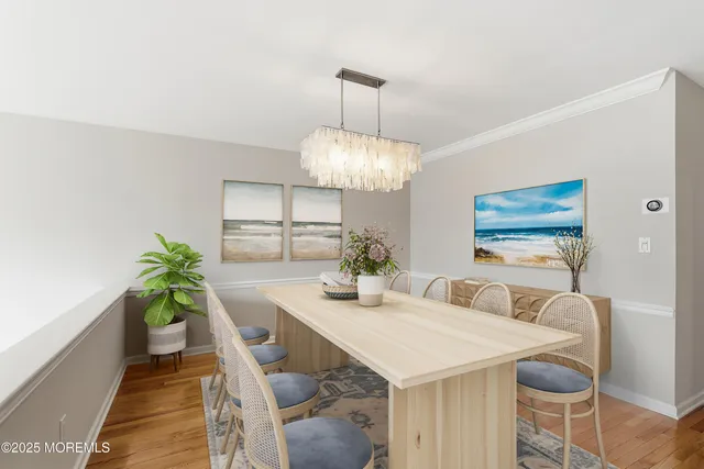 a dining room with furniture and a chandelier