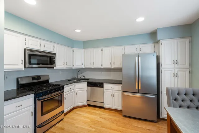 a kitchen with a refrigerator sink and microwave