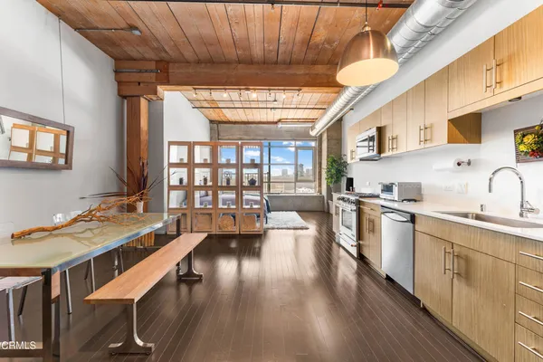 a open kitchen with stainless steel appliances granite countertop a lot of counter space and a wooden floors