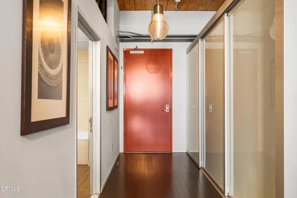 a view of walk in closet with wooden floor
