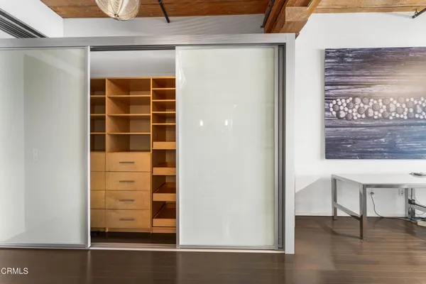 a view of walk in closet with empty racks