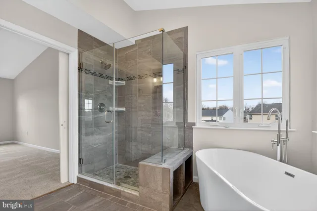 a bathroom with a bathtub and a shower