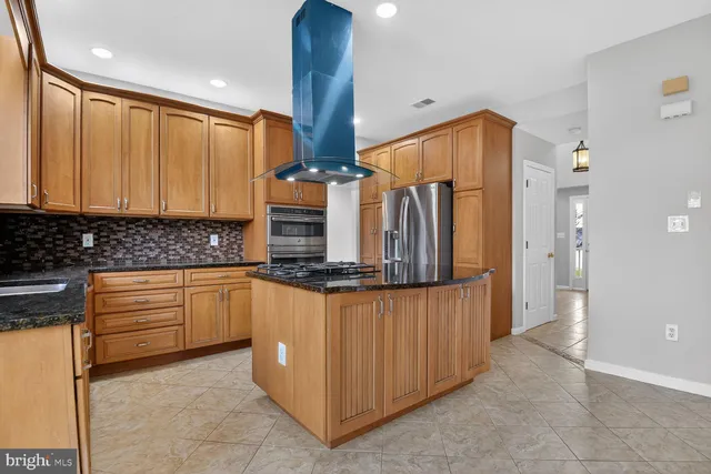 a kitchen with stainless steel appliances a refrigerator and sink
