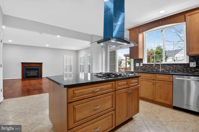 a kitchen with stainless steel appliances granite countertop a sink and a stove
