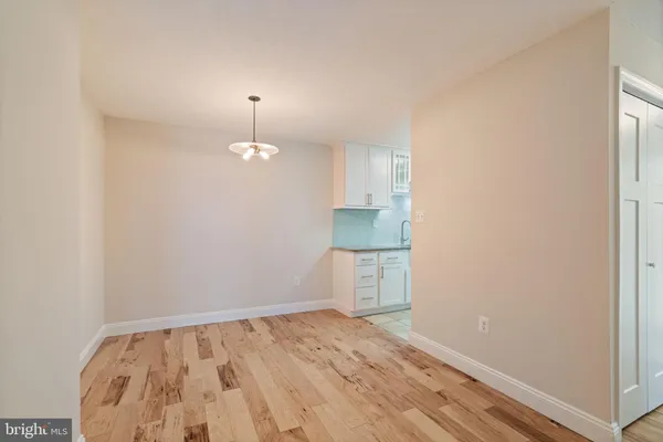 a kitchen with granite countertop a stove cabinets and refrigerator