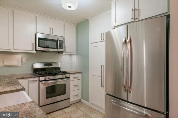 a kitchen with granite countertop a sink and cabinets