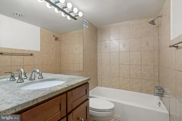 a bathroom with a bathtub and a toilet
