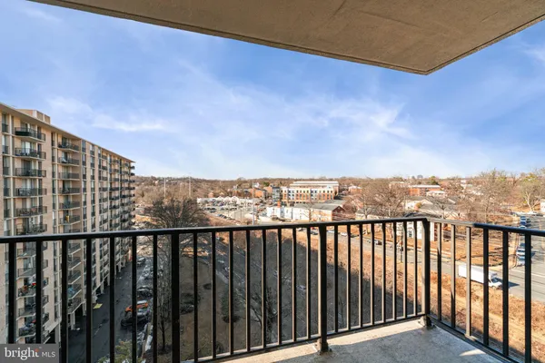 a view of a balcony with wooden floor and fence