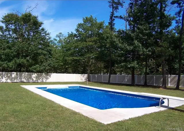 a view of a swimming pool with an outdoor space and seating area