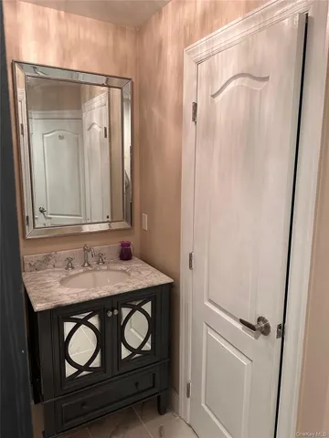 a bathroom with a sink a vanity and a mirror