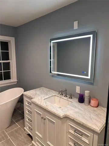a bathroom with a toilet and a mirror