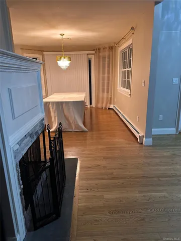 a view of a livingroom with wooden floor and staircase