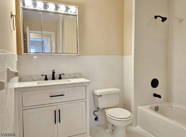 a white toilet sitting next to a bathroom sink