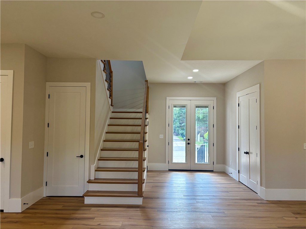 854 Perkins Creek Road Seneca, SC 29678 - Photo 9 of 34 Warm wood flooring and an elegant open staircase welcome guests into the home.