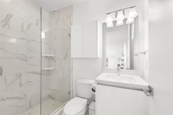 a bathroom with a sink toilet and shower