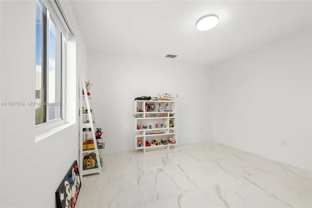 a bathroom with a tub a sink and a large mirror