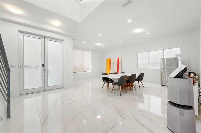a view of living room with furniture and a book shelf