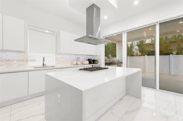 a kitchen with a sink and a refrigerator