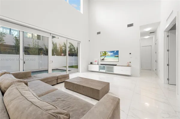 a living room with furniture and a large window