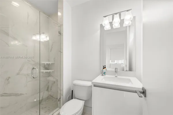 a bathroom with a sink toilet and shower