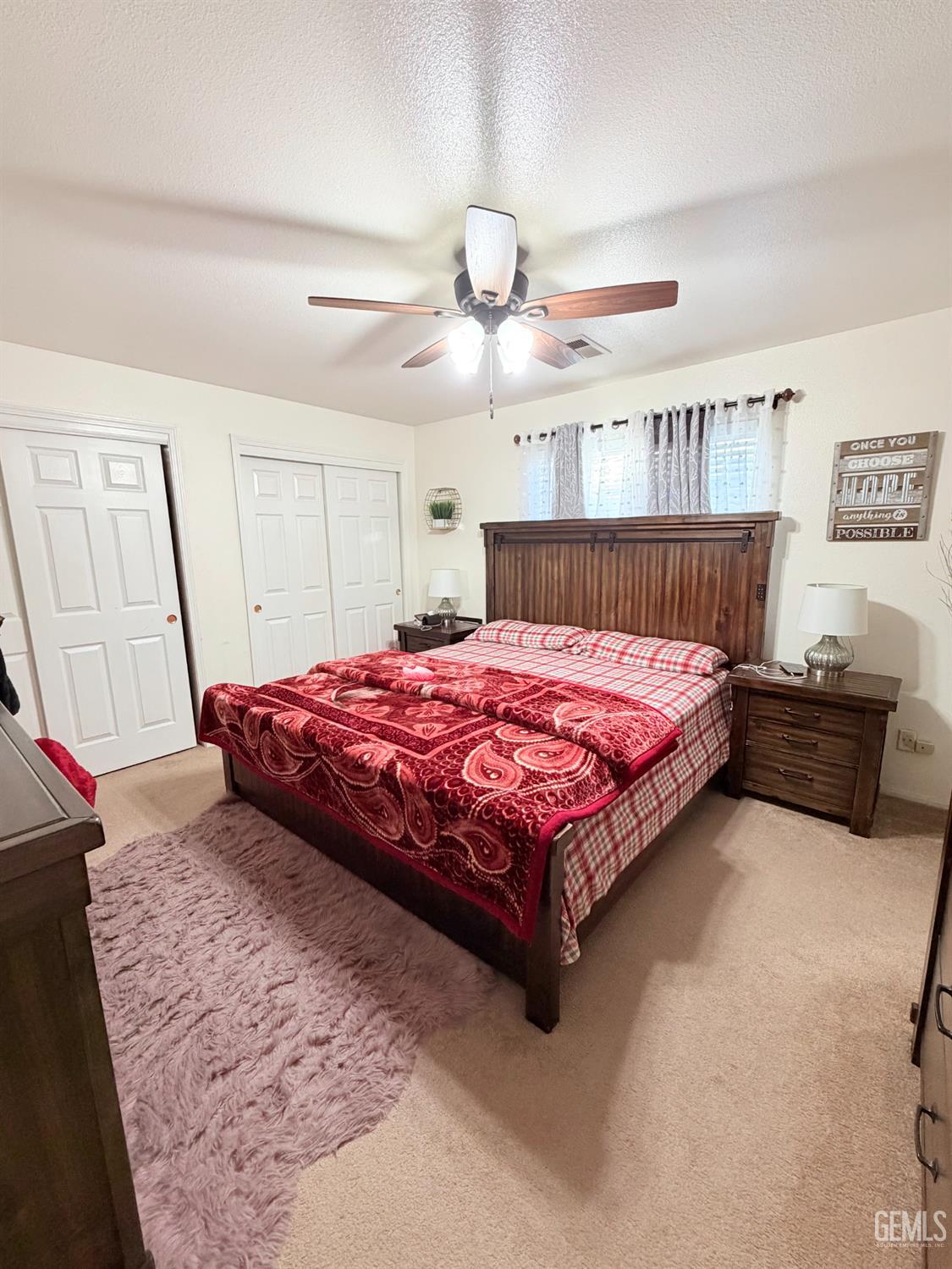 Undisclosed Address Bakersfield, CA 93313 - Photo 11 of 18 a bedroom with a bed and a chandelier
