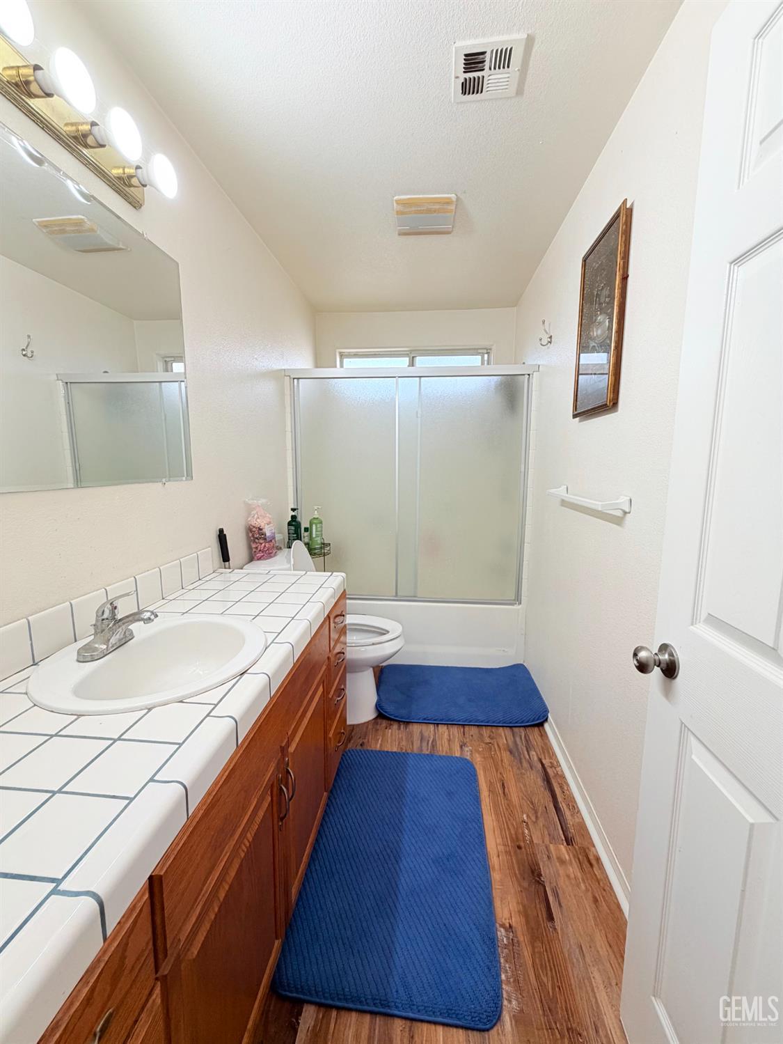 Undisclosed Address Bakersfield, CA 93313 - Photo 12 of 18 a bathroom with a sink and a mirror