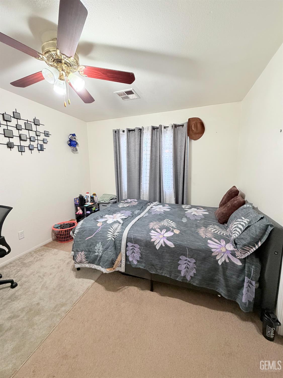 Undisclosed Address Bakersfield, CA 93313 - Photo 13 of 18 a bed sitting in a bedroom next to a lamp