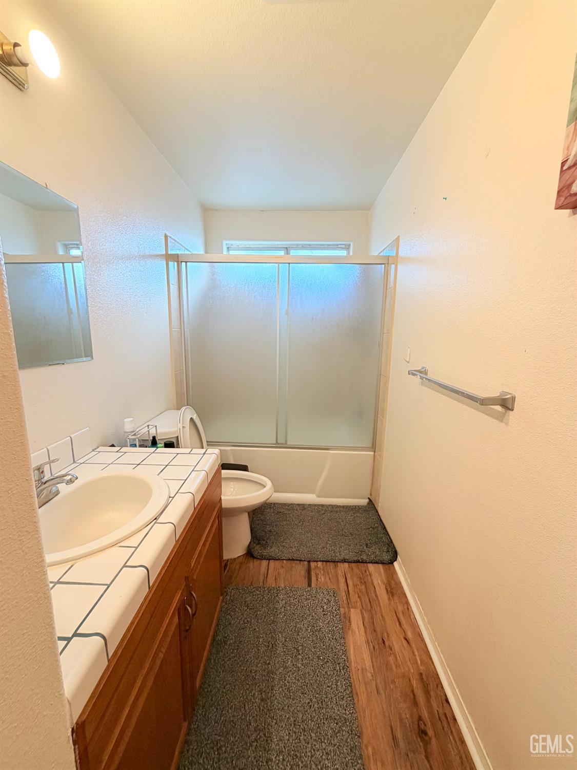 Undisclosed Address Bakersfield, CA 93313 - Photo 15 of 18 a bathroom with a sink a toilet and shower