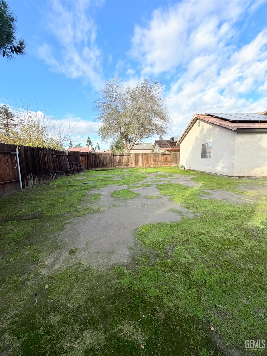 Undisclosed Address Bakersfield, CA 93313 - Photo 17 of 18 a view of a big yard with a house