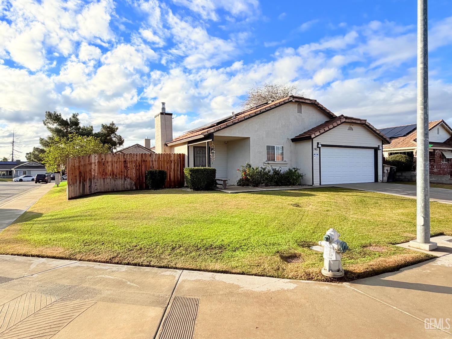 Undisclosed Address Bakersfield, CA 93313 - Photo 2 of 18 a front view of a house with a yard