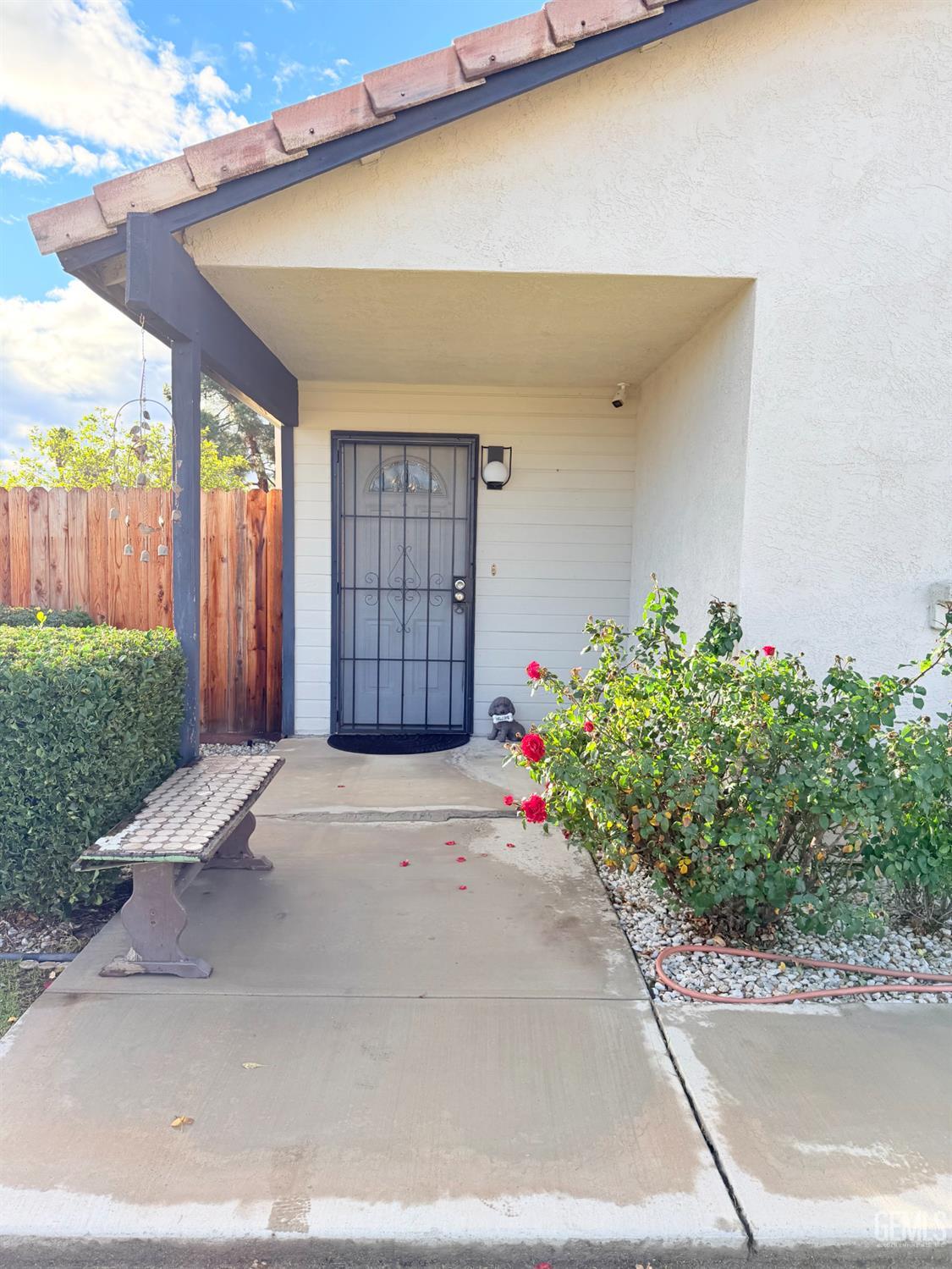 Undisclosed Address Bakersfield, CA 93313 - Photo 3 of 18 a front view of a house with a yard and garage