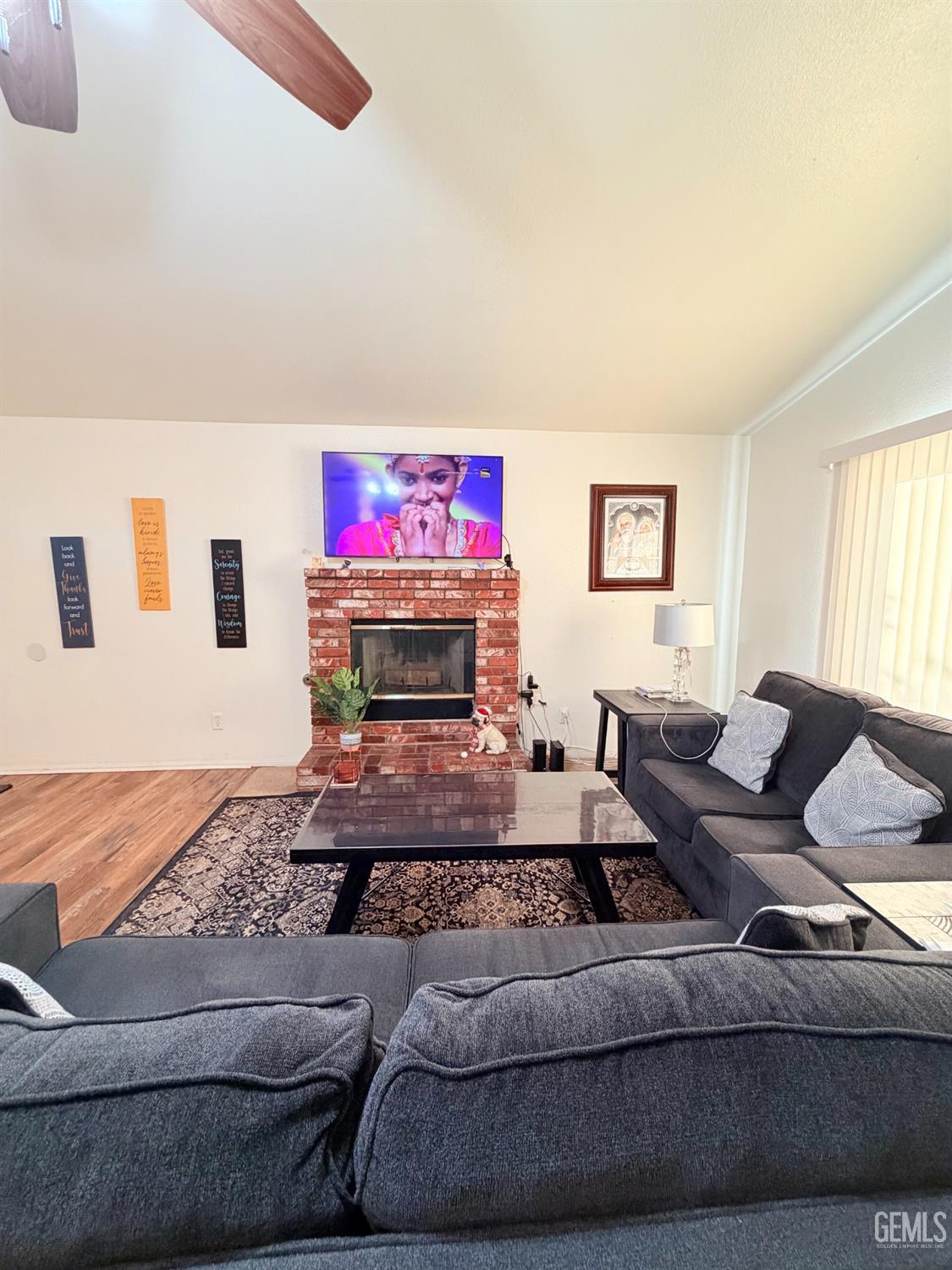 Undisclosed Address Bakersfield, CA 93313 - Photo 8 of 18 a living room with furniture and a fireplace