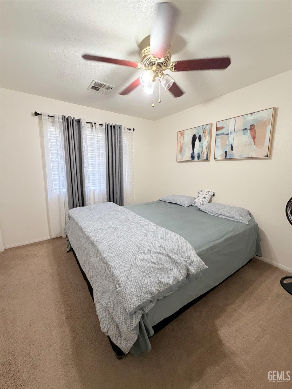 Undisclosed Address Bakersfield, CA 93313 - Photo 10 of 18 a bedroom with a bed and a chandelier