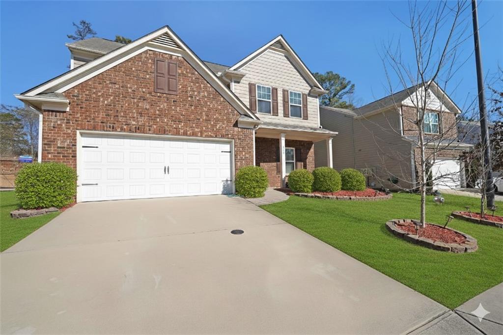 a front view of a house with a yard and garage