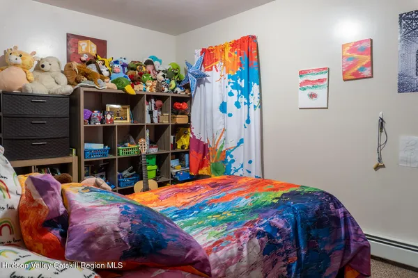 a bedroom with a bed and a bookshelf