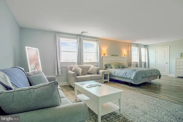 a bedroom with a bed and a couch