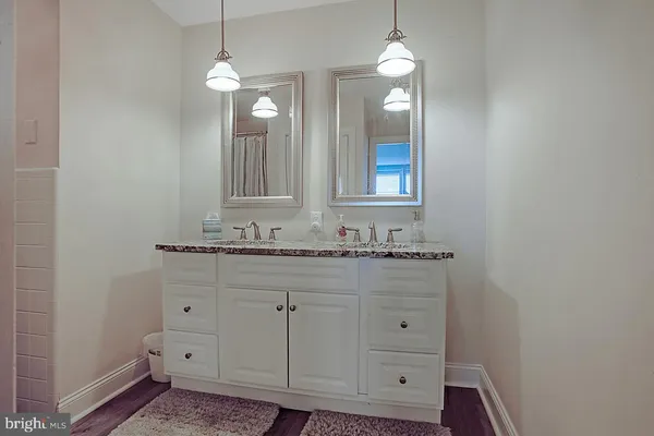 a view of a bathroom with wooden floor