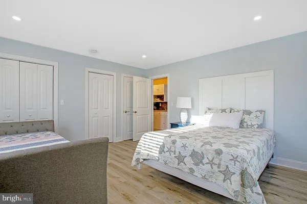 a bedroom with a large bed and a painting