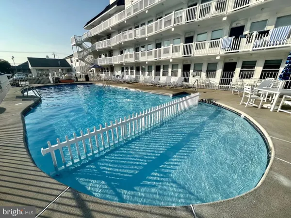 a view of a swimming pool with outdoor seating