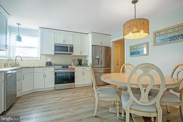 a kitchen with furniture a kitchen island wooden floor and a window