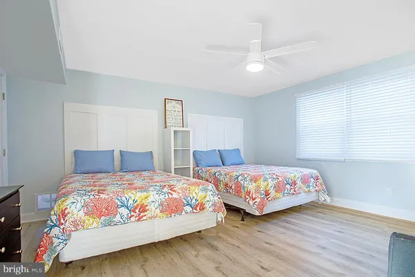 a bedroom with furniture and a wooden floor