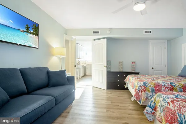 a bedroom with a bed wooden floor and window